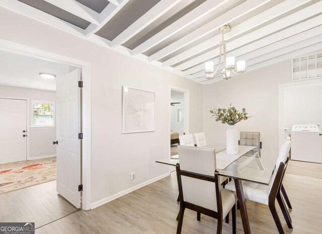 1340 Hawthorne Ave SE, Smyrna, GA 30080 - dining space featuring washer / clothes dryer, baseboards, visible vents, a notable chandelier, and light wood-type flooring