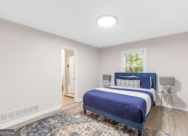 1340 Hawthorne Ave SE, Smyrna, GA 30080 - bedroom with visible vents, baseboards, ensuite bath, and wood finished floors