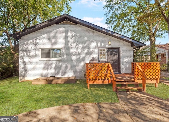 1340 Hawthorne Ave SE, Smyrna, GA 30080 - exterior space with brick siding, a wooden deck, and a lawn