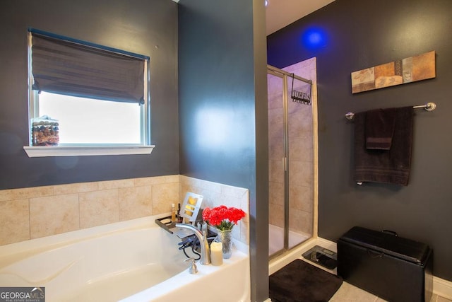 bathroom with a bath and a shower stall