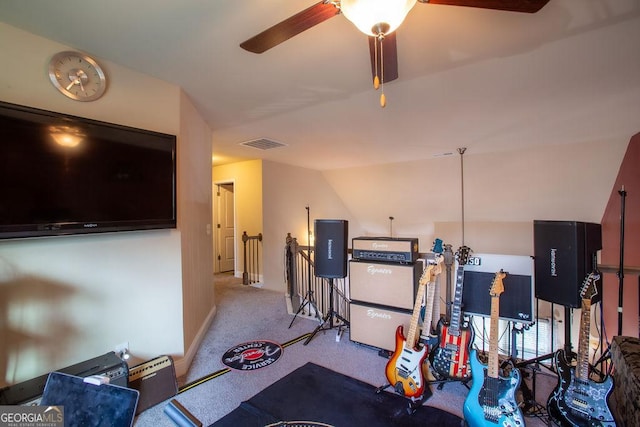 interior space with carpet flooring, a ceiling fan, and visible vents