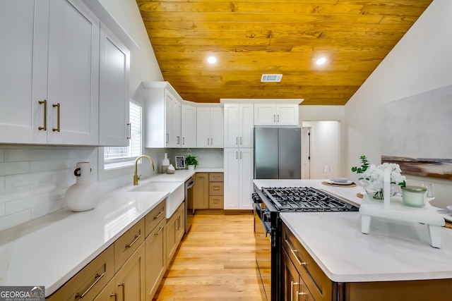 3244 Mount Olive Rd, Atlanta, GA 30344 - kitchen with stainless steel appliances, a sink, wooden ceiling, white cabinetry, and light wood-type flooring