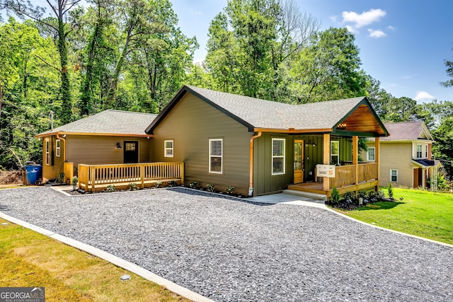 3244 Mount Olive Rd, Atlanta, GA 30344 - chalet / cabin with a shingled roof, a porch, a front lawn, and board and batten siding