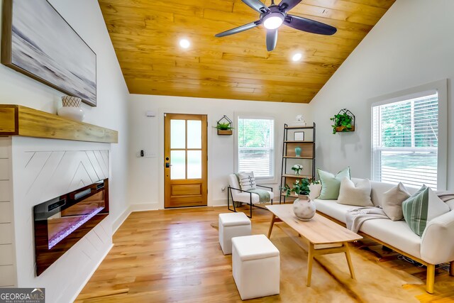 3244 Mount Olive Rd, Atlanta, GA 30344 - living room with a glass covered fireplace, vaulted ceiling, wooden ceiling, plenty of natural light, and light wood-type flooring