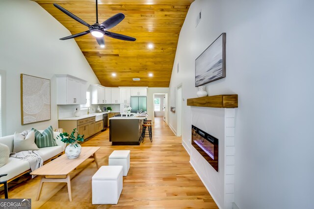 3244 Mount Olive Rd, Atlanta, GA 30344 - living room featuring high vaulted ceiling, a ceiling fan, a glass covered fireplace, light wood finished floors, and wood ceiling