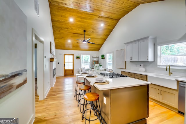 3244 Mount Olive Rd, Atlanta, GA 30344 - kitchen with a sink, stainless steel gas cooktop, a kitchen island, high vaulted ceiling, and ceiling fan