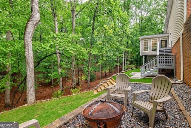 view of yard with a fire pit and stairway
