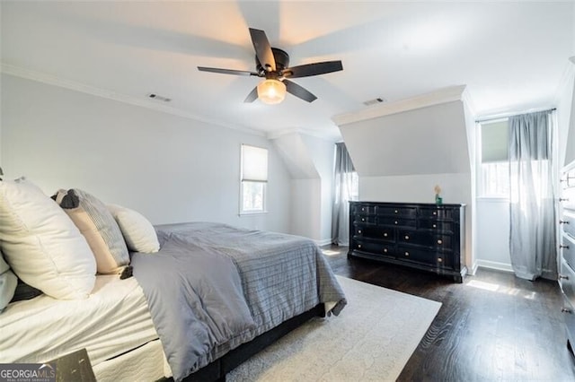 bedroom with wood finished floors, baseboards, crown molding, and ceiling fan