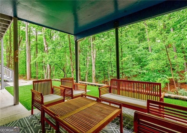 sunroom / solarium with a view of trees