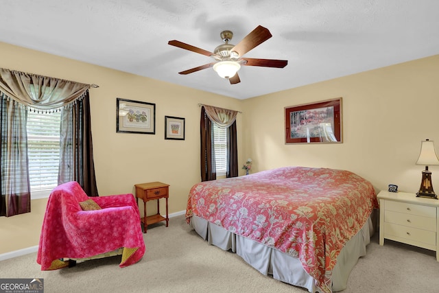 bedroom with carpet, baseboards, and a ceiling fan