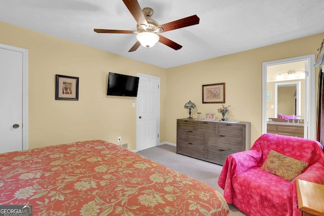 bedroom featuring carpet floors, connected bathroom, ceiling fan, and baseboards