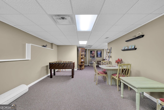 playroom with carpet floors, a drop ceiling, and baseboards