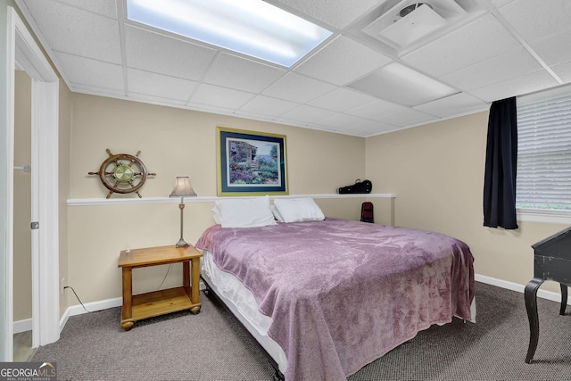 bedroom featuring carpet floors, a paneled ceiling, and baseboards