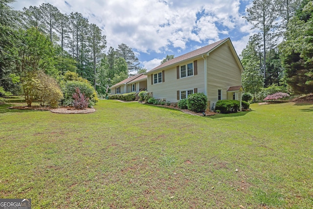 back of property with a yard