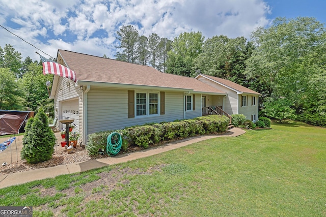 ranch-style house featuring a front lawn, a shingled roof, and an attached garage