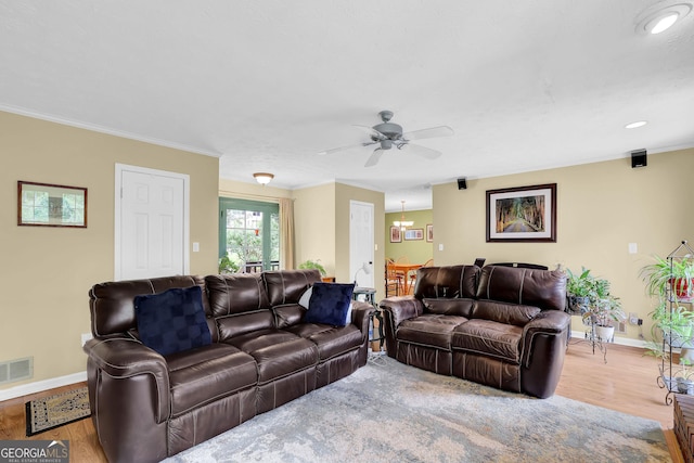 living room with baseboards, wood finished floors, a ceiling fan, crown molding, and recessed lighting