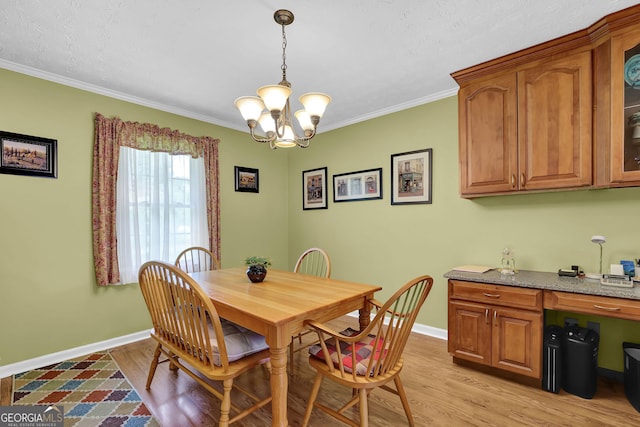 dining area with baseboards, light wood-style flooring, a chandelier, and crown molding
