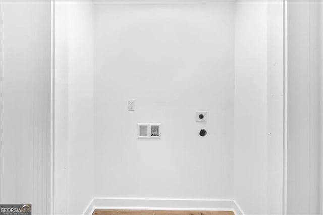washroom featuring electric dryer hookup, baseboards, washer hookup, laundry area, and wood finished floors