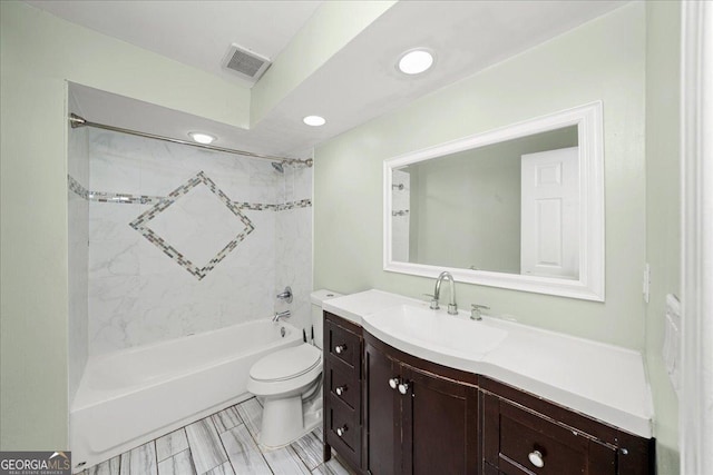 bathroom with vanity, shower / tub combination, toilet, visible vents, and recessed lighting