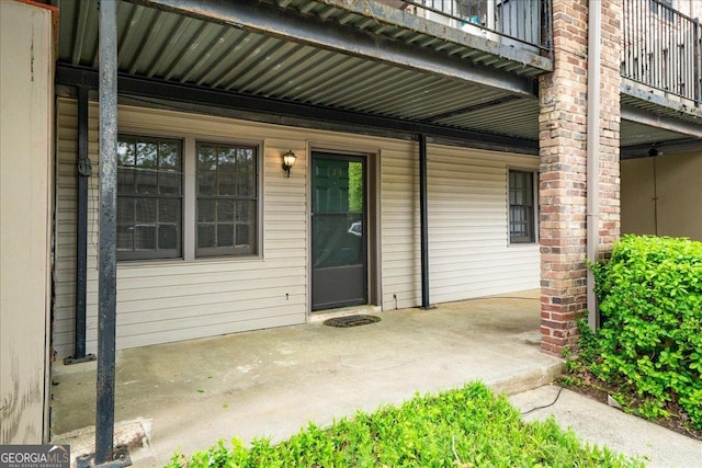 view of exterior entry featuring a balcony