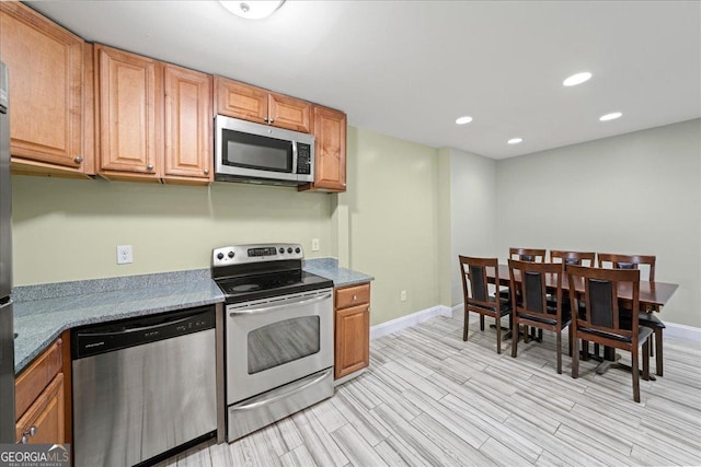 kitchen featuring recessed lighting, baseboards, appliances with stainless steel finishes, and light wood-type flooring