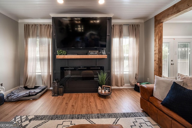 2189 Broad St, Statham, GA 30666 - living room featuring a glass covered fireplace, baseboards, crown molding, and wood finished floors