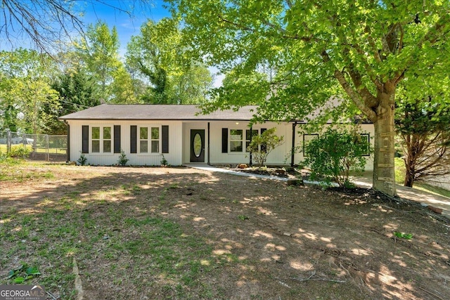 ranch-style house with fence