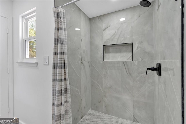 bathroom with a tile shower