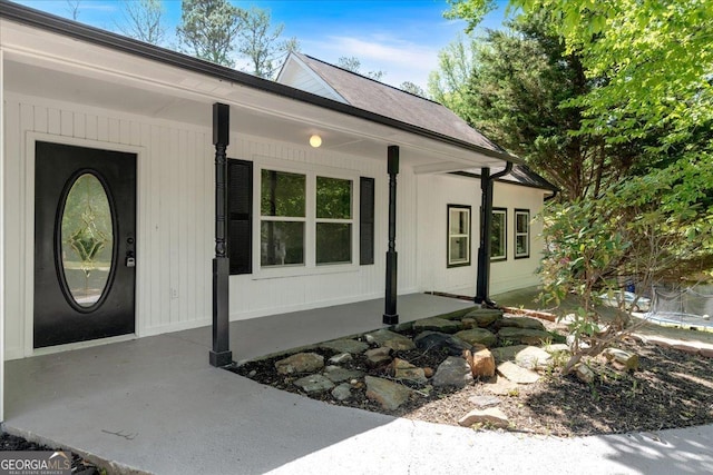 view of exterior entry featuring a porch