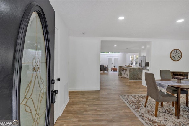entryway with baseboards, recessed lighting, and light wood-style floors