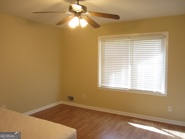 2107 Briarwood Ct, Snellville, GA 30078 - unfurnished bedroom featuring visible vents, baseboards, ceiling fan, and wood finished floors