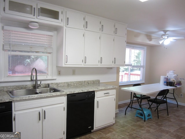 2107 Briarwood Ct, Snellville, GA 30078 - kitchen featuring white cabinetry, black dishwasher, light countertops, a sink, and baseboards