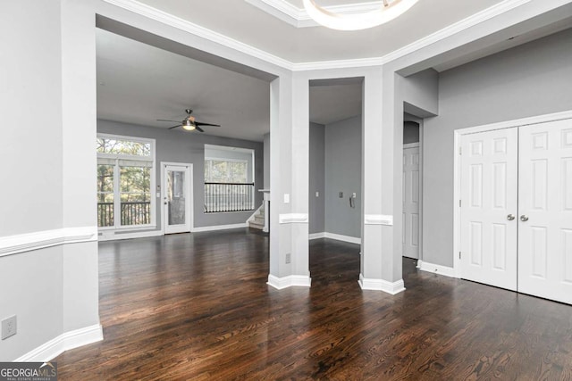 unfurnished living room with wood finished floors, ceiling fan, baseboards, and stairway