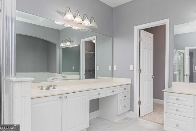 full bathroom with a shower with shower door, vanity, and baseboards