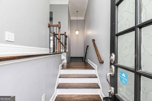 staircase featuring crown molding and baseboards