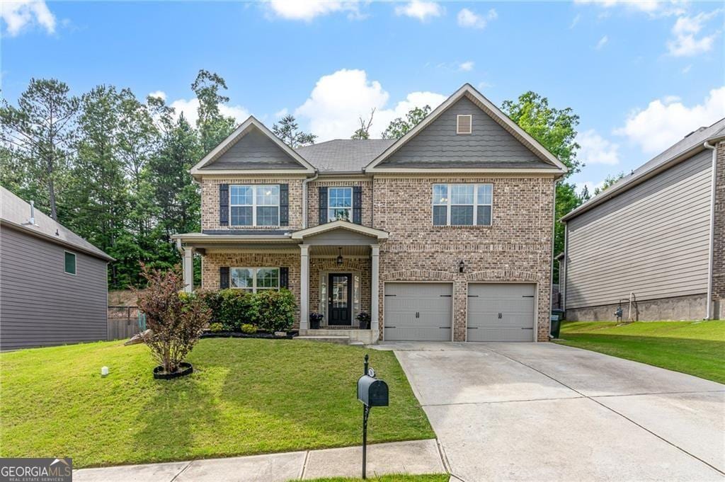 180 Cleburne Pl, Acworth, GA 30101 - craftsman inspired home featuring brick siding, a garage, a front lawn, and driveway
