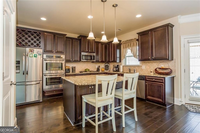 kitchen with decorative backsplash, decorative light fixtures, stainless steel appliances, and dark brown cabinets