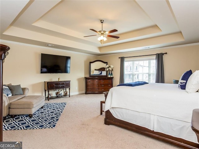 bedroom featuring carpet floors, ceiling fan, and a raised ceiling