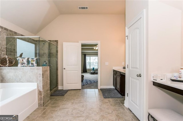 bathroom featuring visible vents, tile patterned floors, a shower stall, vaulted ceiling, and a garden tub