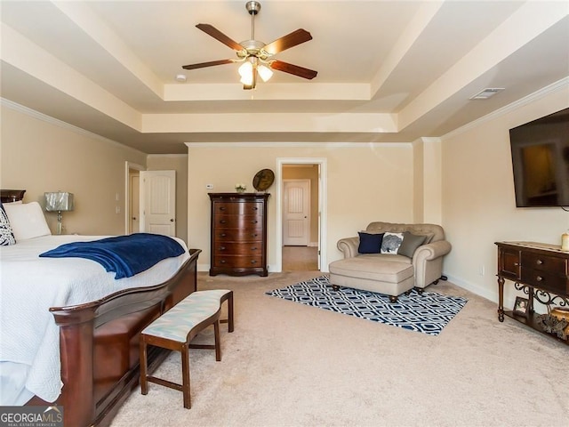 bedroom featuring ceiling fan, light colored carpet, a raised ceiling, visible vents, and ornamental molding