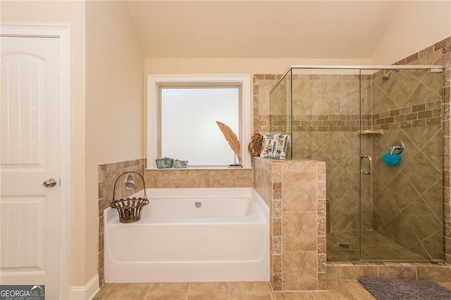 bathroom featuring a garden tub and a shower stall
