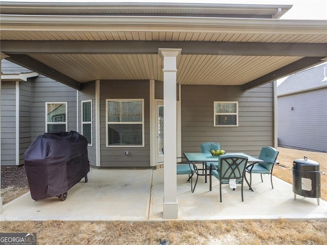 view of patio with outdoor dining space and a grill