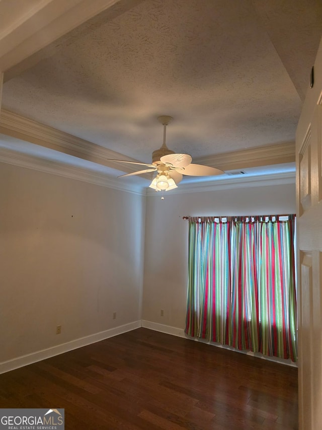 spare room with baseboards, wood finished floors, crown molding, and ceiling fan