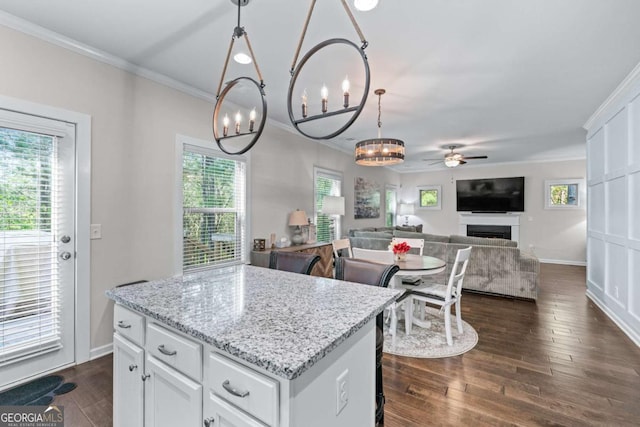 6424 Barker Station Walk, Sugar Hill, GA 30518 - kitchen featuring a chandelier, ceiling fan, ornamental molding, white cabinets, and a center island