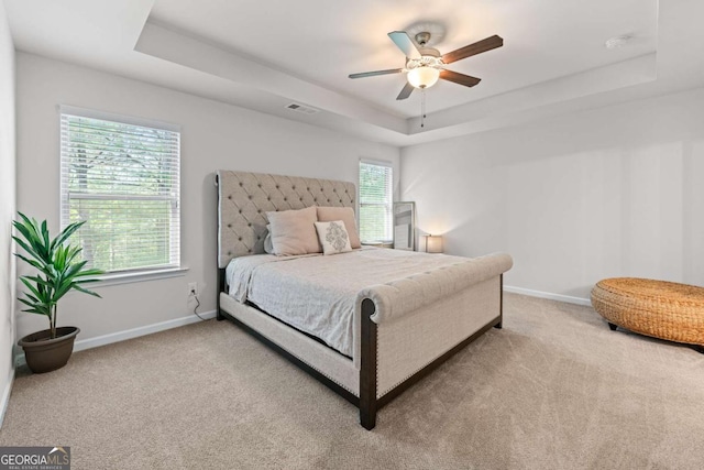 6424 Barker Station Walk, Sugar Hill, GA 30518 - bedroom with a tray ceiling, light colored carpet, and ceiling fan