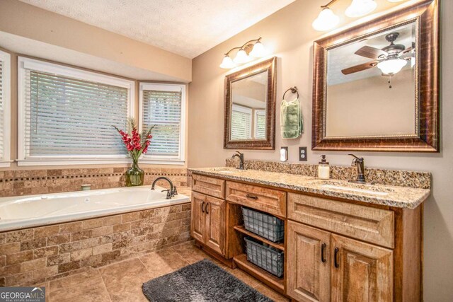 469 Kimberly Ct, Mcdonough, GA 30252 - full bathroom featuring double vanity, a garden tub, ceiling fan, a textured ceiling, and tile patterned floors