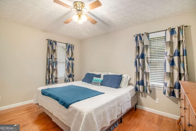 469 Kimberly Ct, Mcdonough, GA 30252 - bedroom with light wood finished floors, a textured ceiling, and ceiling fan