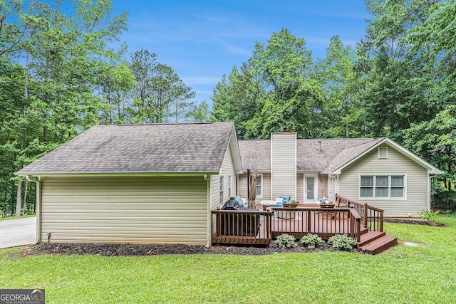 469 Kimberly Ct, Mcdonough, GA 30252 - back of property with a wooden deck, a chimney, roof with shingles, and a lawn