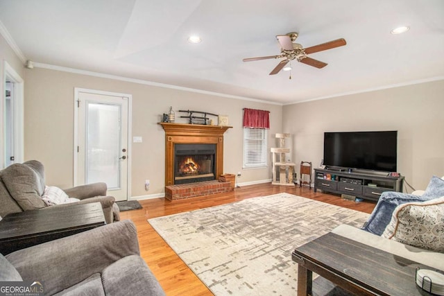 469 Kimberly Ct, Mcdonough, GA 30252 - living area with ceiling fan, crown molding, recessed lighting, wood finished floors, and a brick fireplace