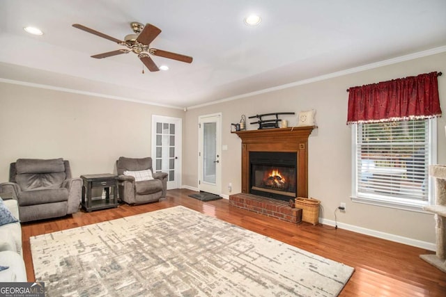 469 Kimberly Ct, Mcdonough, GA 30252 - living room with a glass covered fireplace, crown molding, a ceiling fan, wood finished floors, and recessed lighting